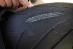 Worn out motorcycle tire cords showing