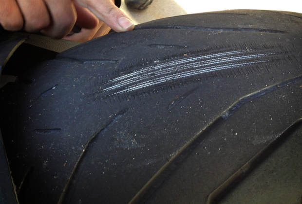 Worn out motorcycle tire cords showing