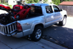 Load a motorcycle in the back of a truck