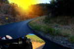 motorcycle riding a corner at sunrise