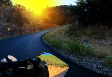 motorcycle riding a corner at sunrise