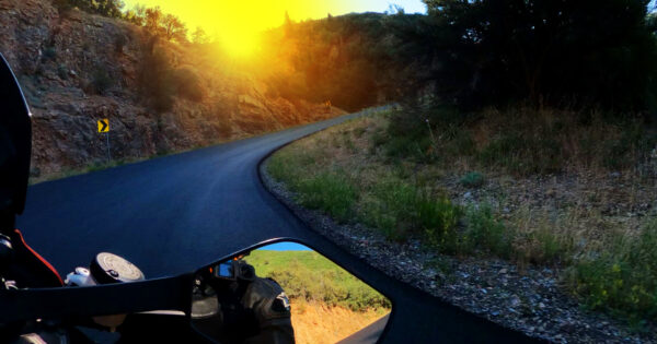 motorcycle riding a corner at sunrise