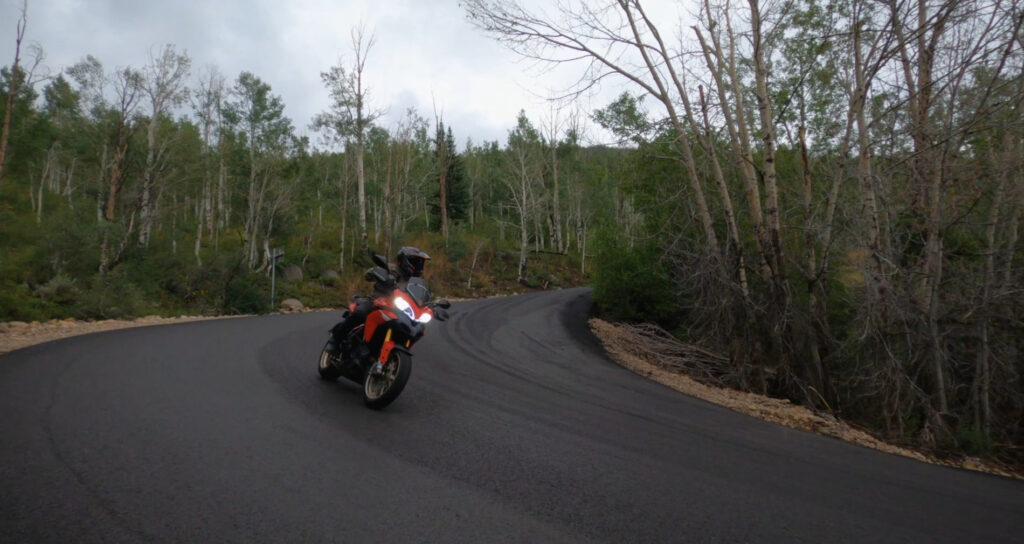 Ducati Multistrada Motorcycle riding down steep downhill corner in the rain