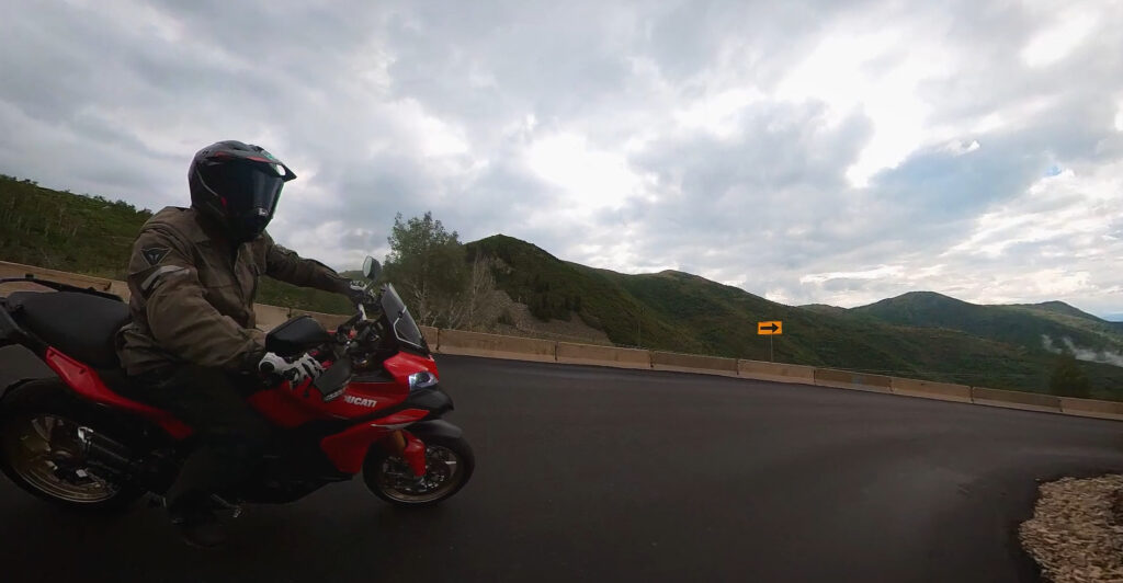 Motorcycle trail braking through a downhill corner