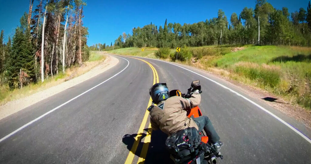 Motorcycle riding through a corner on a mountain road