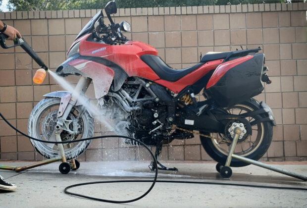 Washing a motorcycle in the driveway