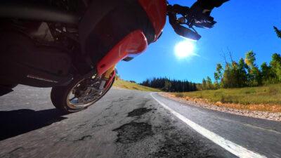 Motorcycle Leaning in a corner on a road in bad condition