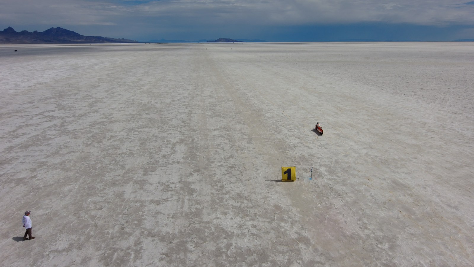 A Bonneville racing lane stretching toward the mountains with a lone course marker