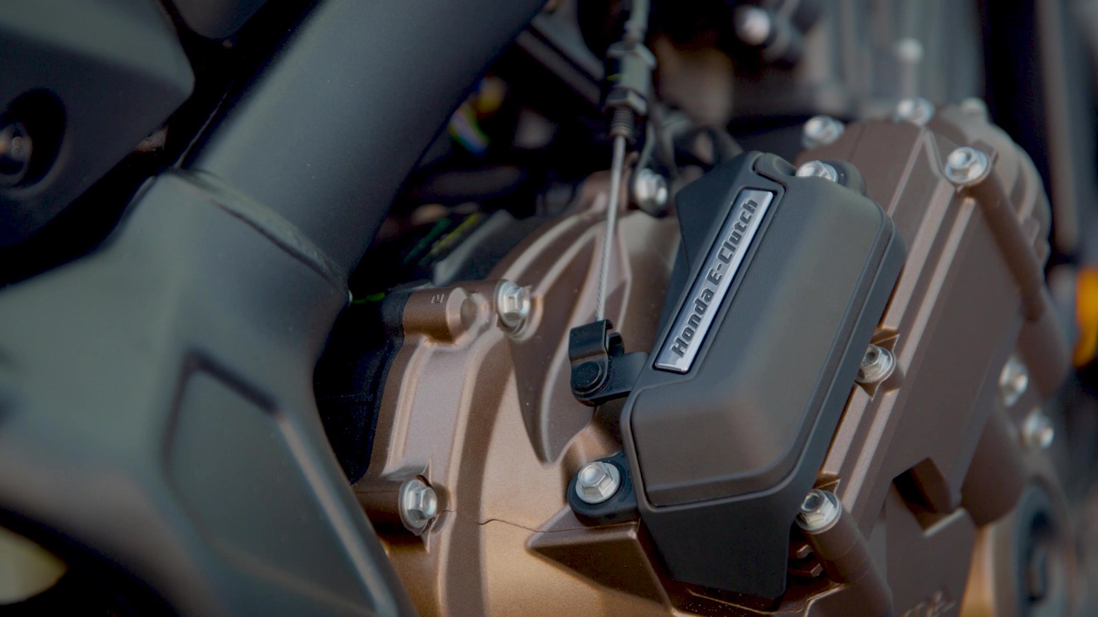Close-up of an automated clutch actuator mounted on a motorcycle engine