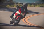 A rider leaning a sportbike through a mountain corner