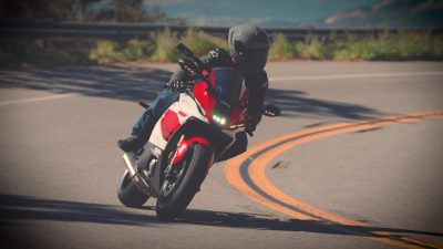 A rider leaning a sportbike through a mountain corner