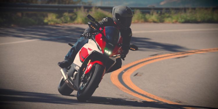 A rider leaning a sportbike through a mountain corner