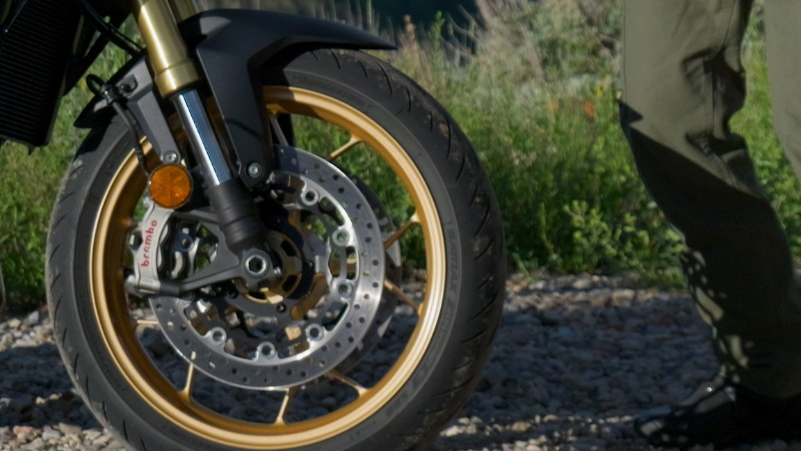 Close detail of the Honda CB1000 Hornet SP front end with gold Showa fork and Brembo brake