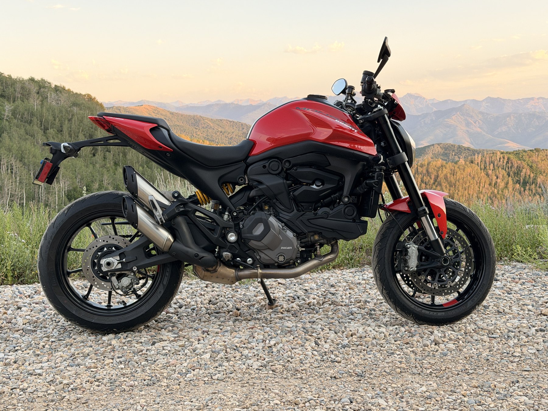 The red Ducati Monster parked at a mountain overlook