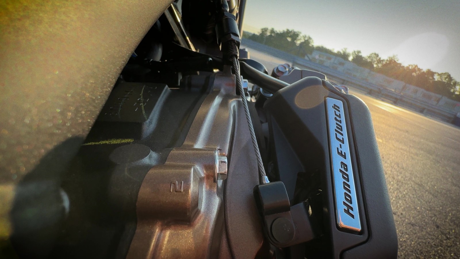 Close detail of the Honda E-Clutch actuator badge on the right side of the CB650R engine