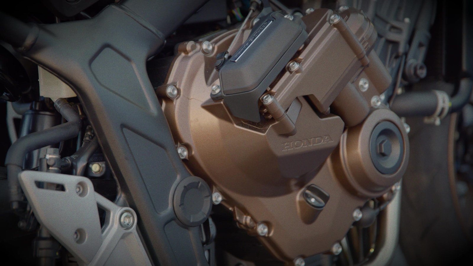 Close-up of the Honda E-Clutch actuator mounted on the side of the CB650R engine