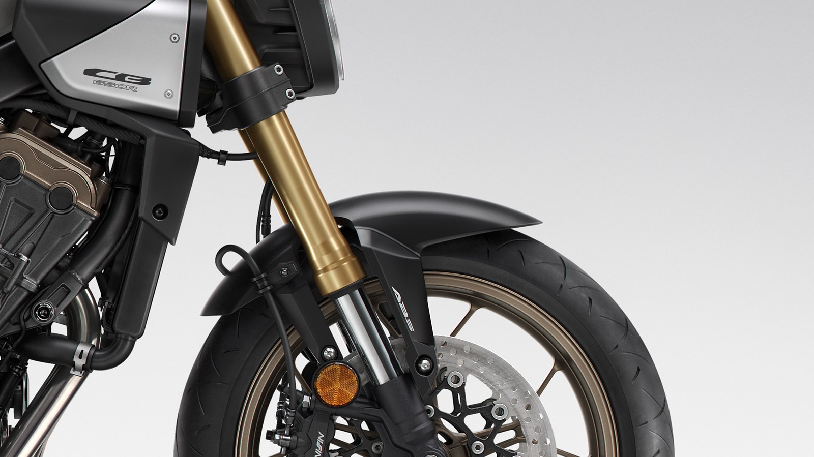 Detail of the Honda CB650R gold Showa big-piston fork and radial-mounted Nissin front brake