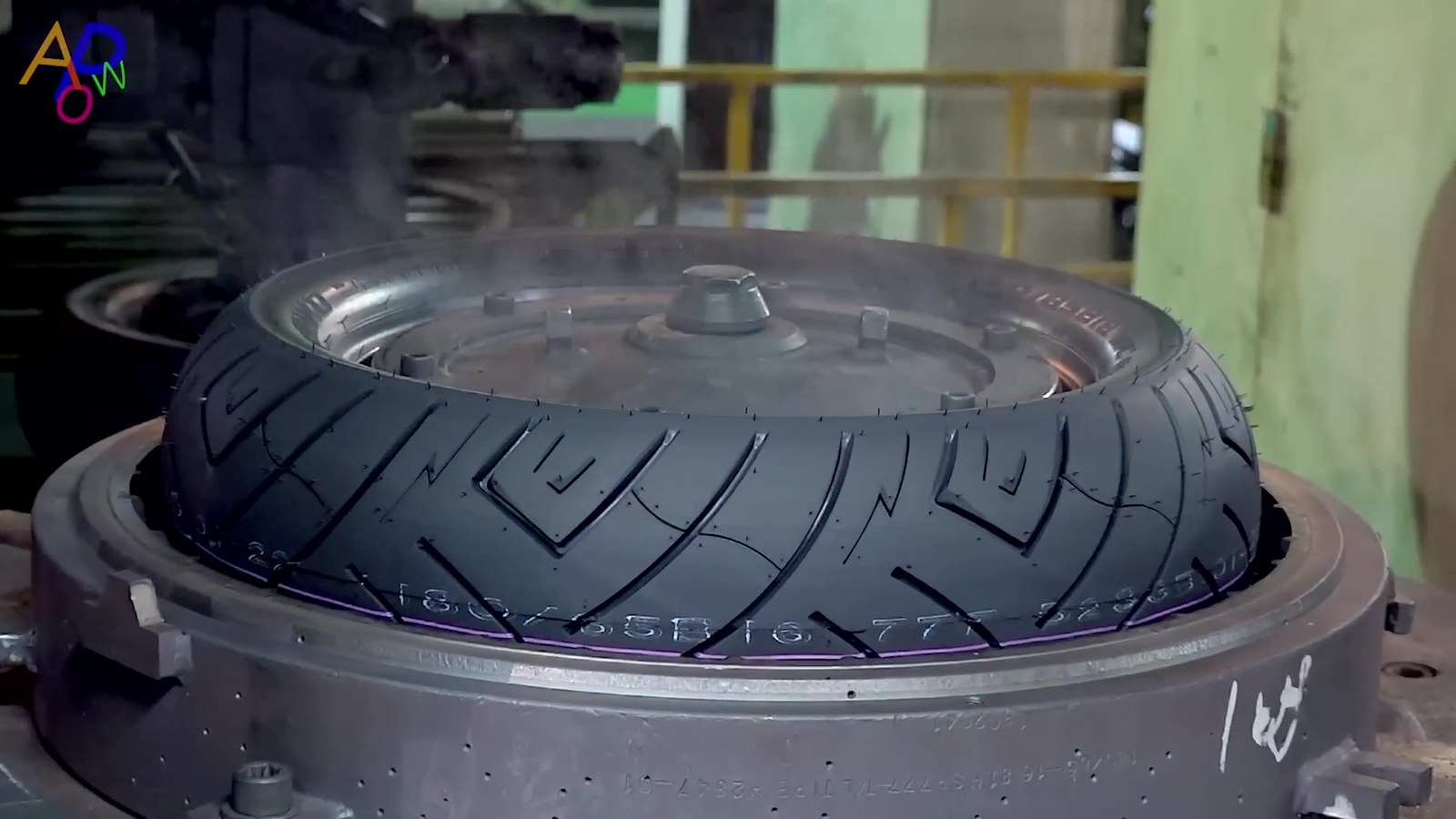 A motorcycle tire being handled during manufacturing