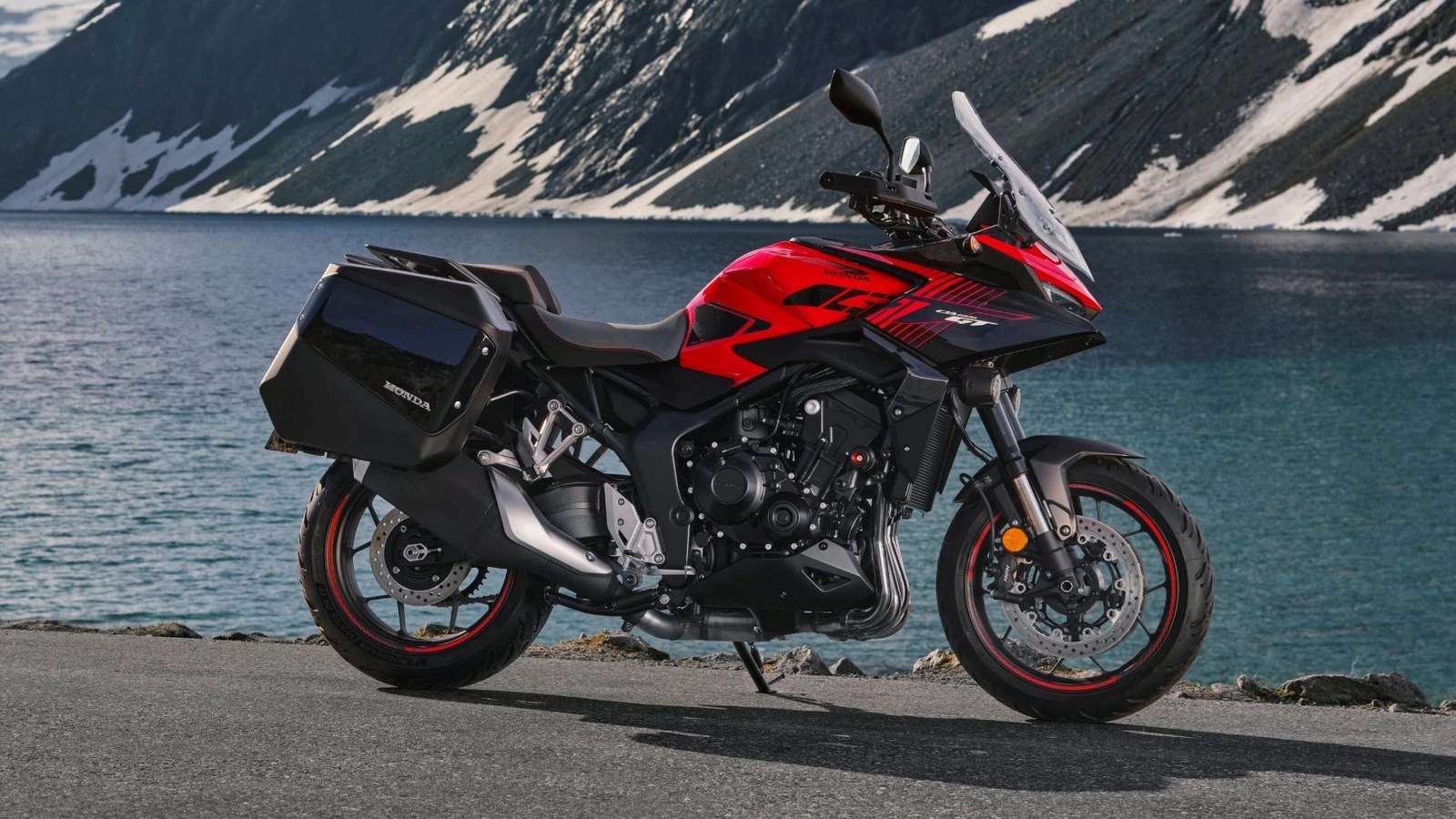 The upcoming Honda CB1000GT sport-touring model with luggage beside a lake