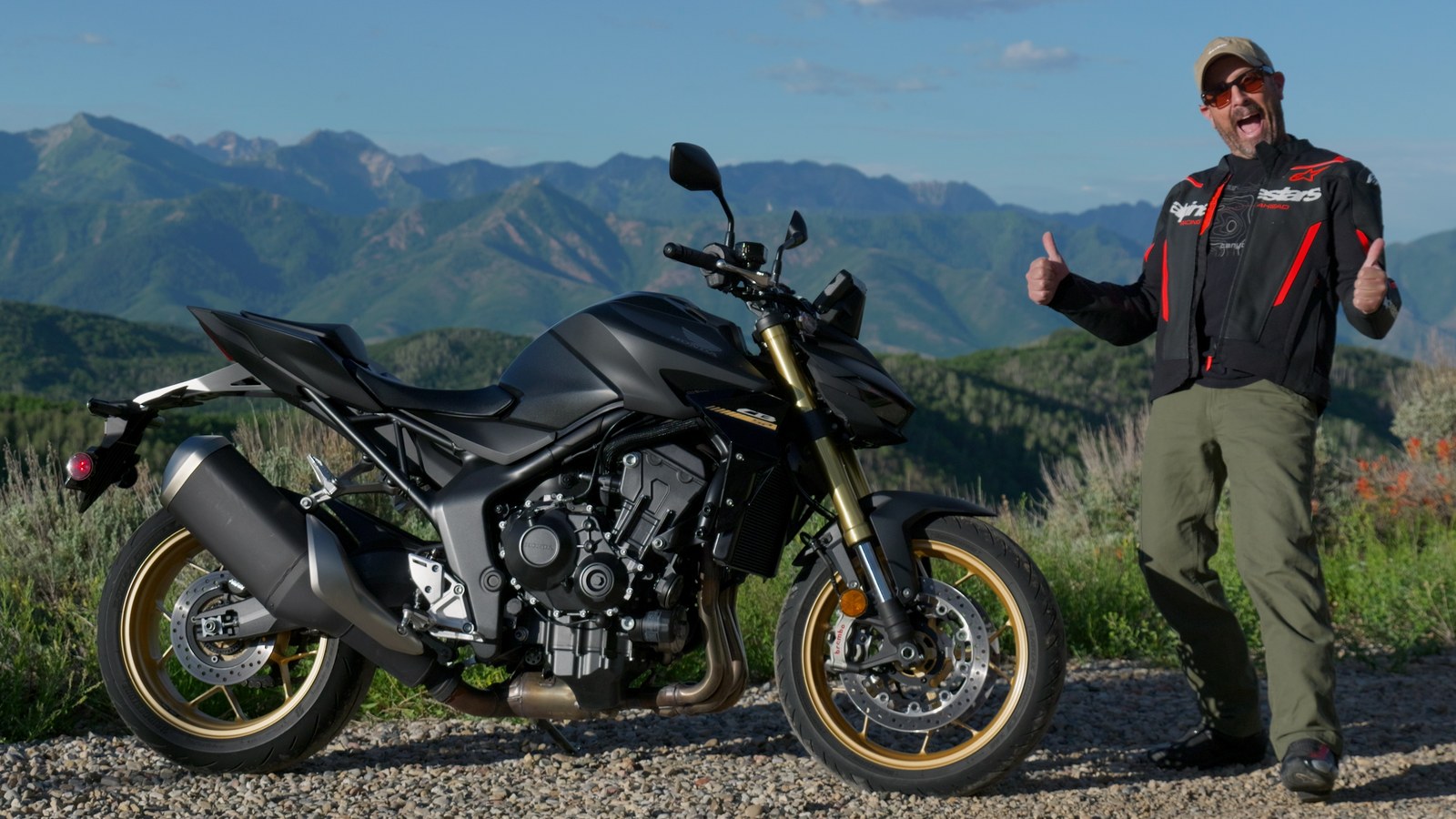 The 2026 Honda CB1000 Hornet SP naked motorcycle in black with gold wheels parked on a mountain pullout