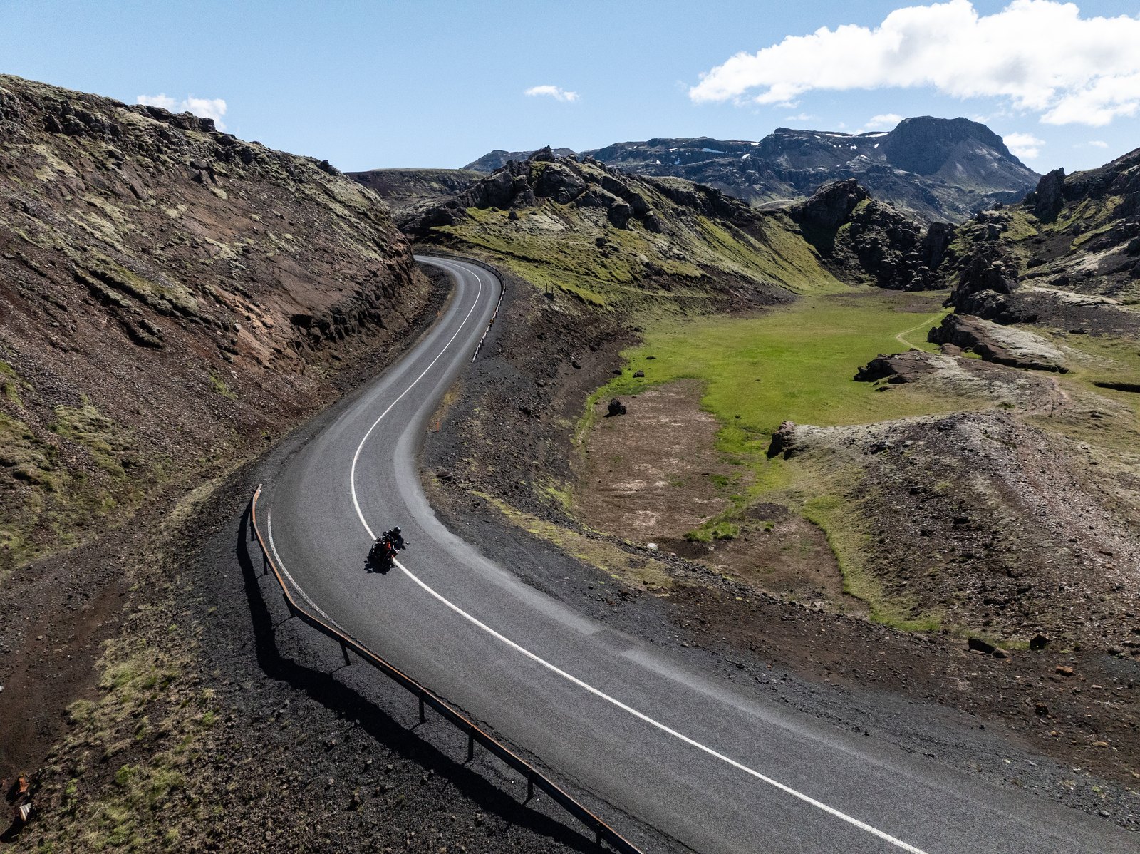 Norton Atlas on a sweeping mountain road through the Icelandic highlands