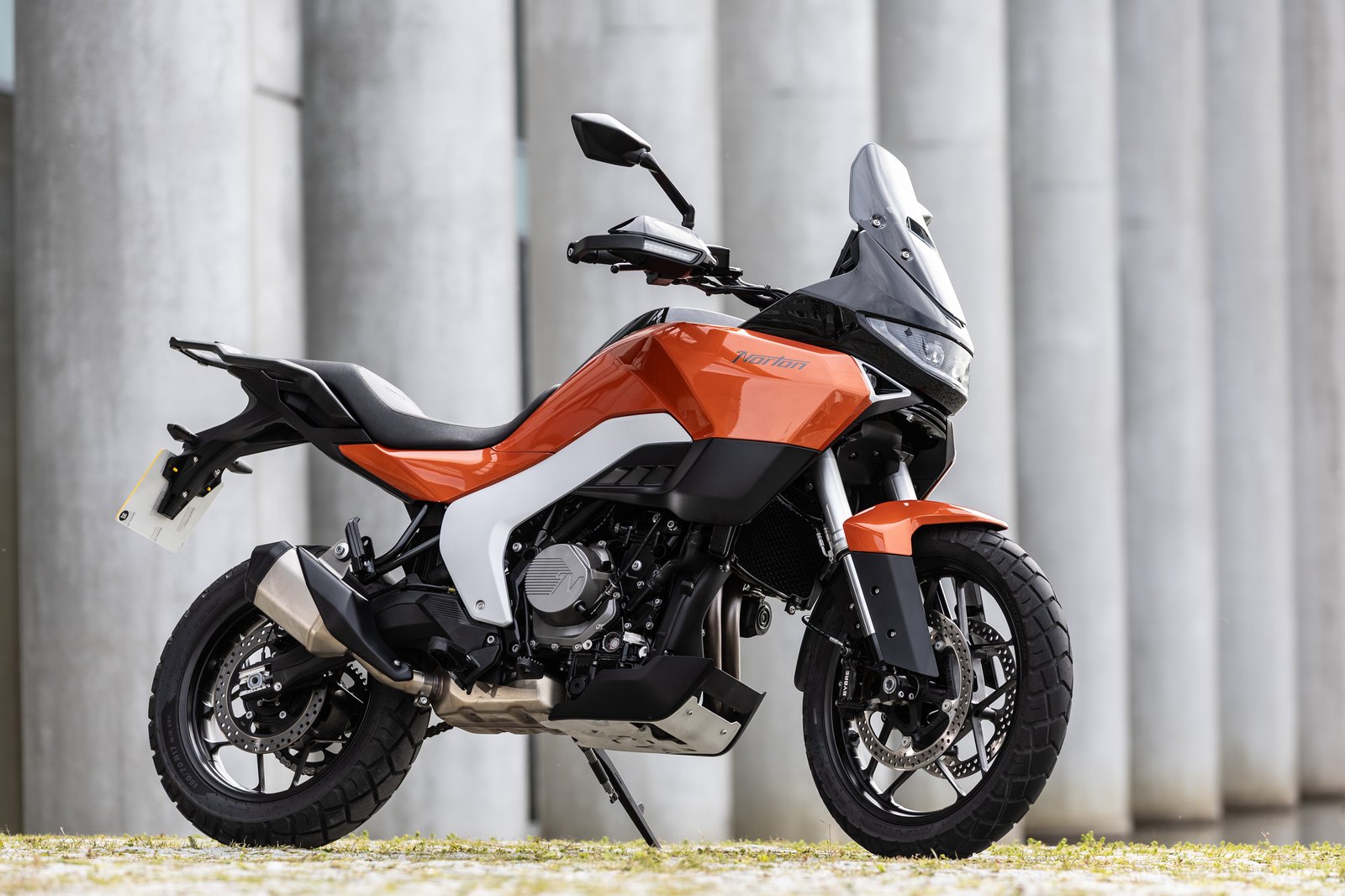 2026 Norton Atlas parked on a mountain road, side profile showing the orange bodywork