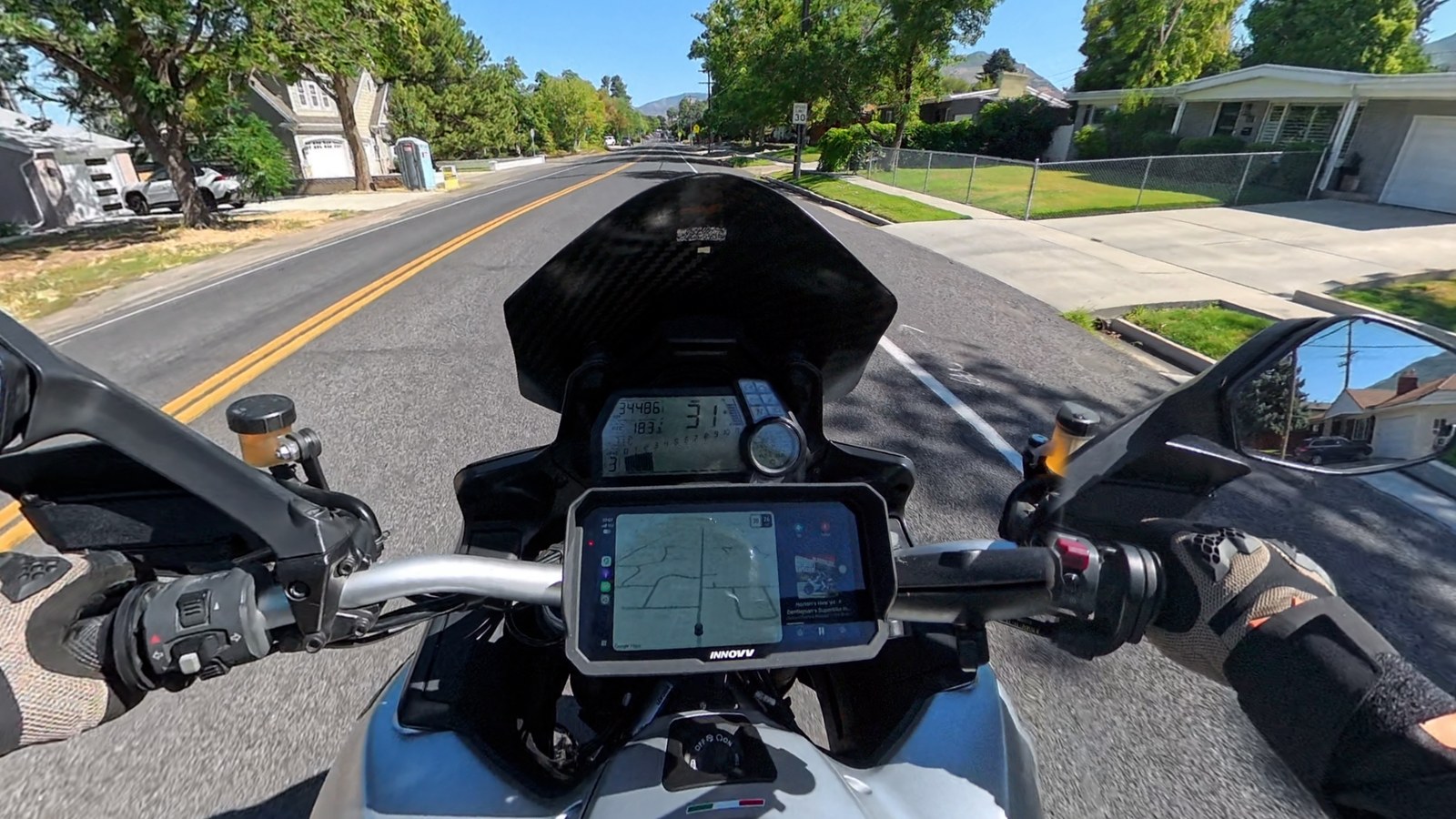 The INNOVV N3 showing Google Maps navigation through CarPlay on a suburban street