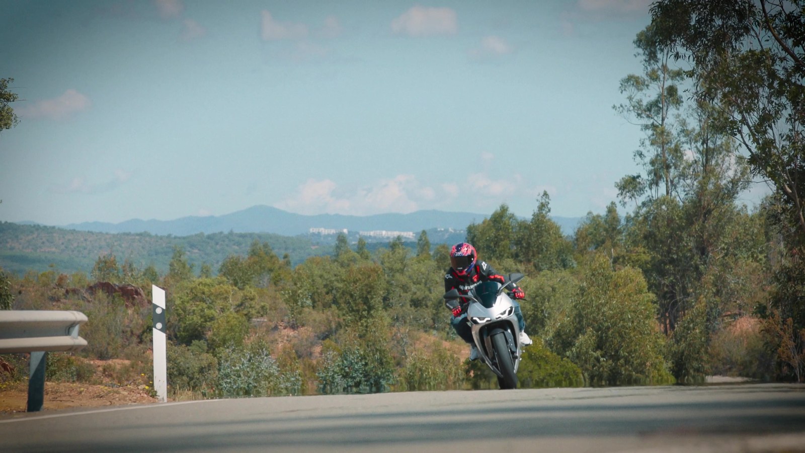 Riding the Norton Manx R through a corner on a Spanish mountain road