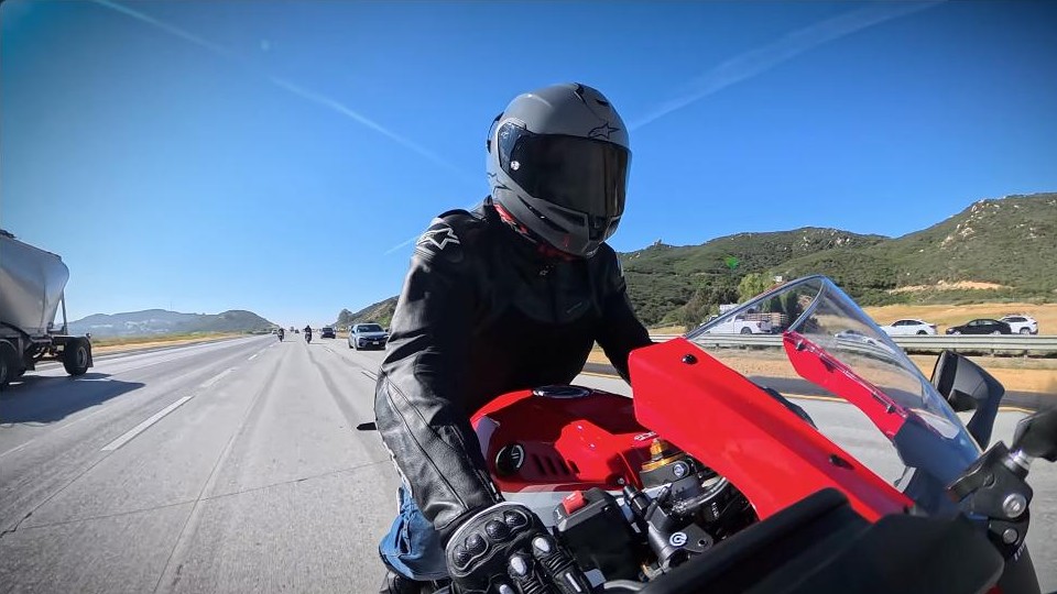 Riding the 2026 Yamaha R7 on the highway, cockpit and clip-ons in view