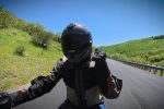 Point-of-view riding a motorcycle on an open canyon road