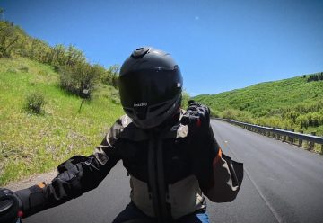 Point-of-view riding a motorcycle on an open canyon road