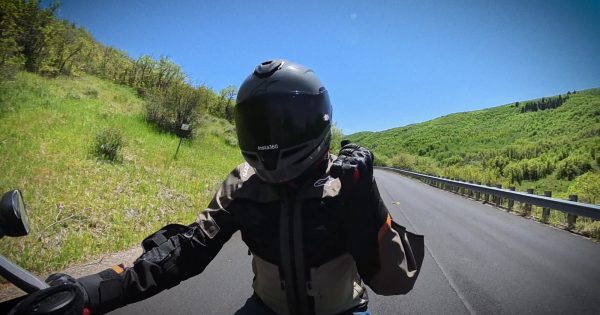 Point-of-view riding a motorcycle on an open canyon road