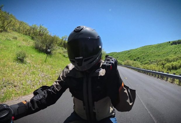 Point-of-view riding a motorcycle on an open canyon road