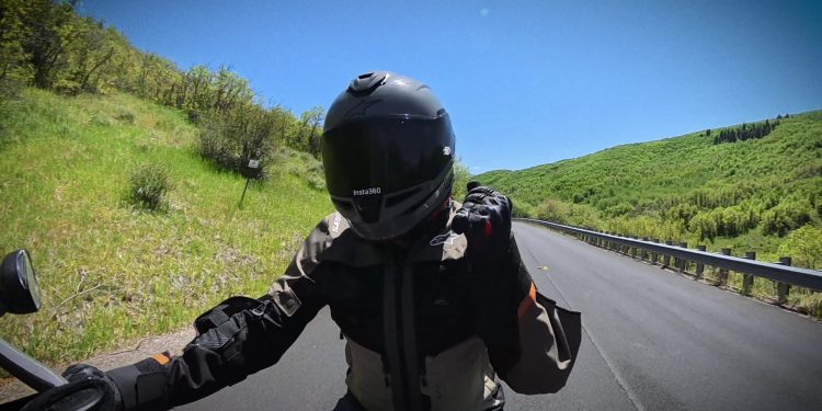 Point-of-view riding a motorcycle on an open canyon road