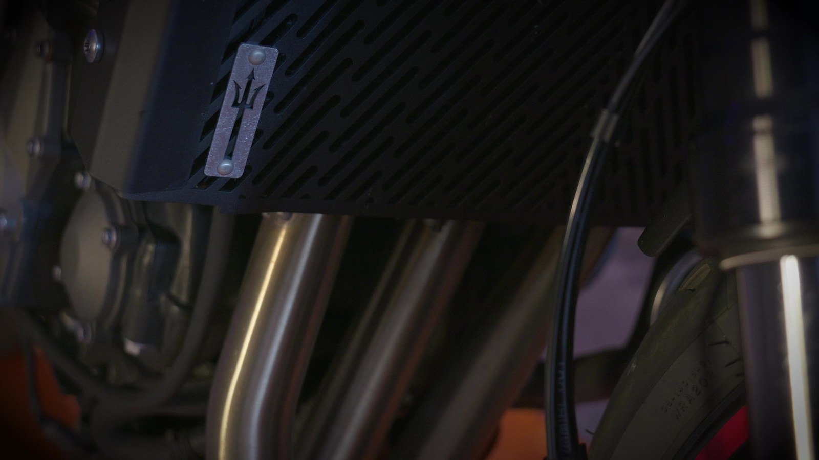 Close-up of the Triumph Trident 660 triple-cylinder engine and exhaust