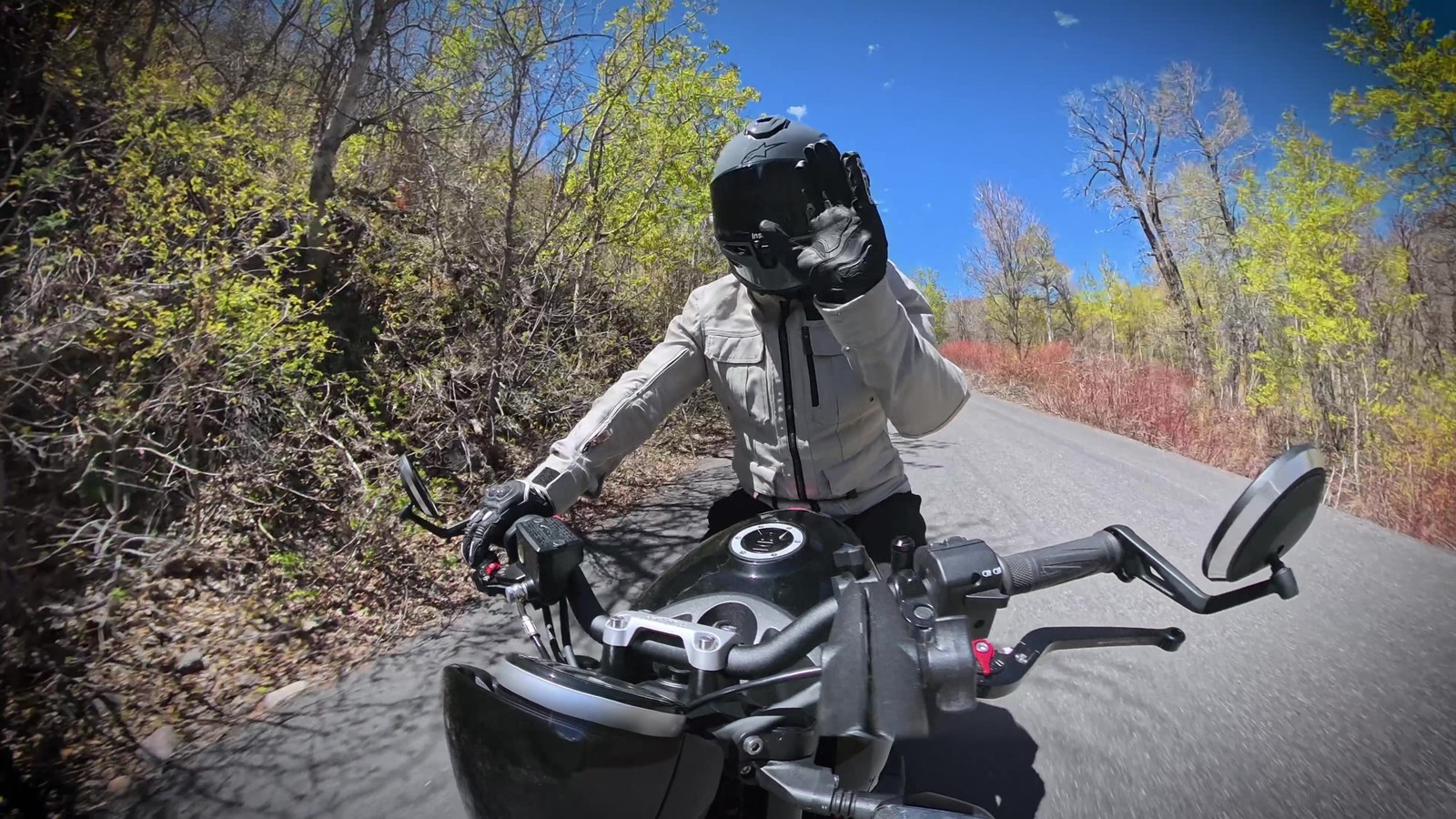 A point-of-view shot riding the Triumph Trident 660 through a spring canyon corner