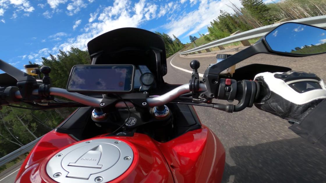 A phone clamped to the bars: cheap, convenient, and slowly murdering its own camera