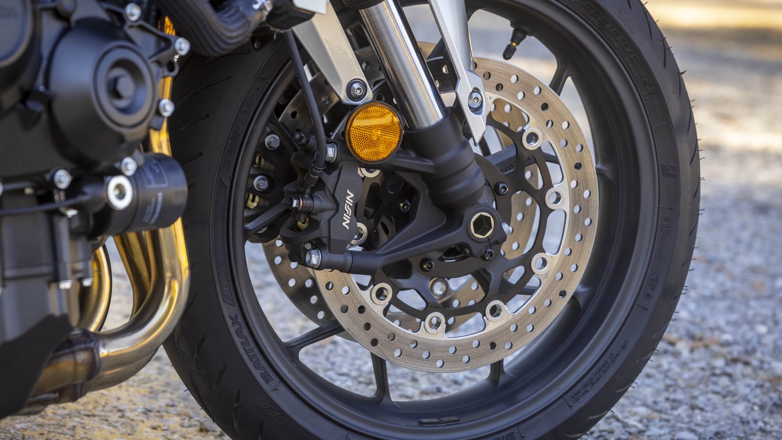 Radial Nissin four-piston calipers on 310mm floating discs.