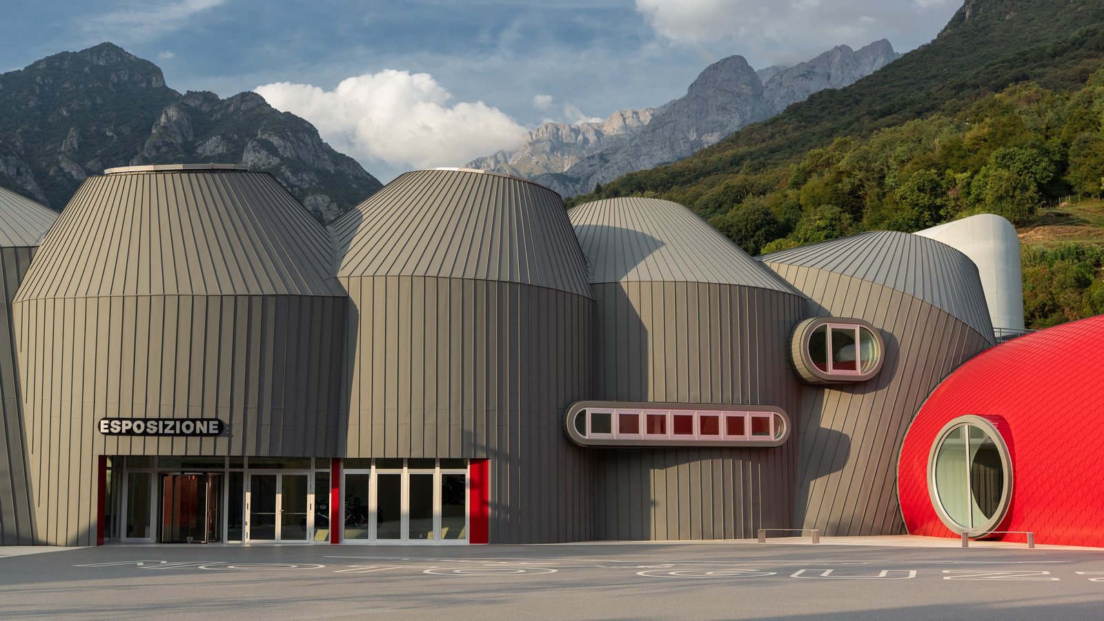 The new Moto Guzzi museum buildings in Mandello del Lario with the Alps behind