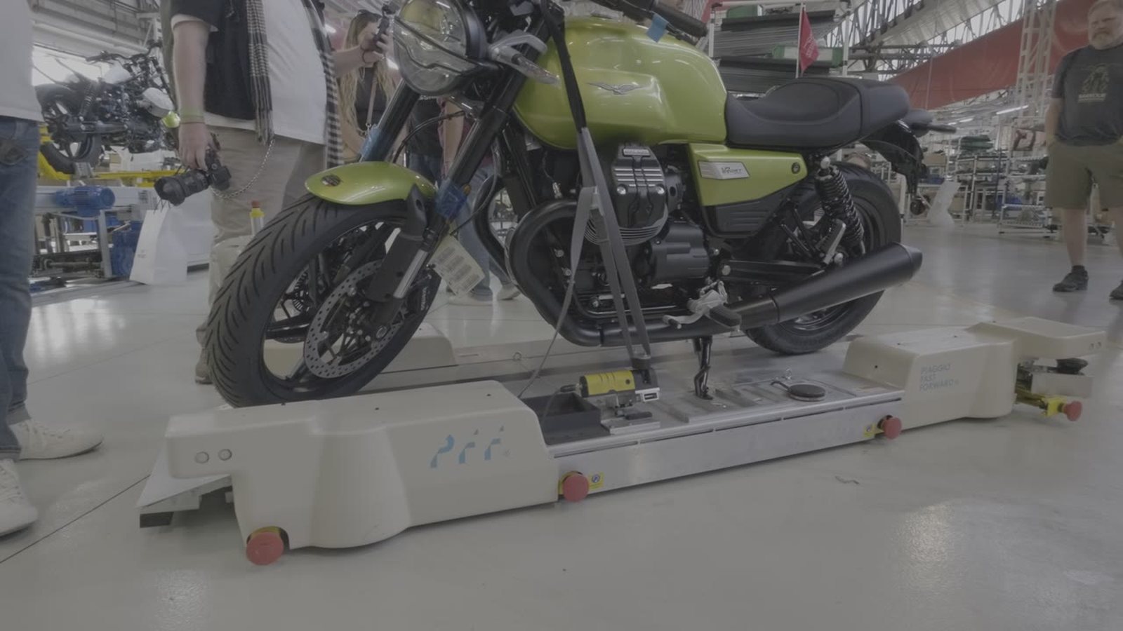 A finished Moto Guzzi strapped to a kilo ground drone on the factory floor