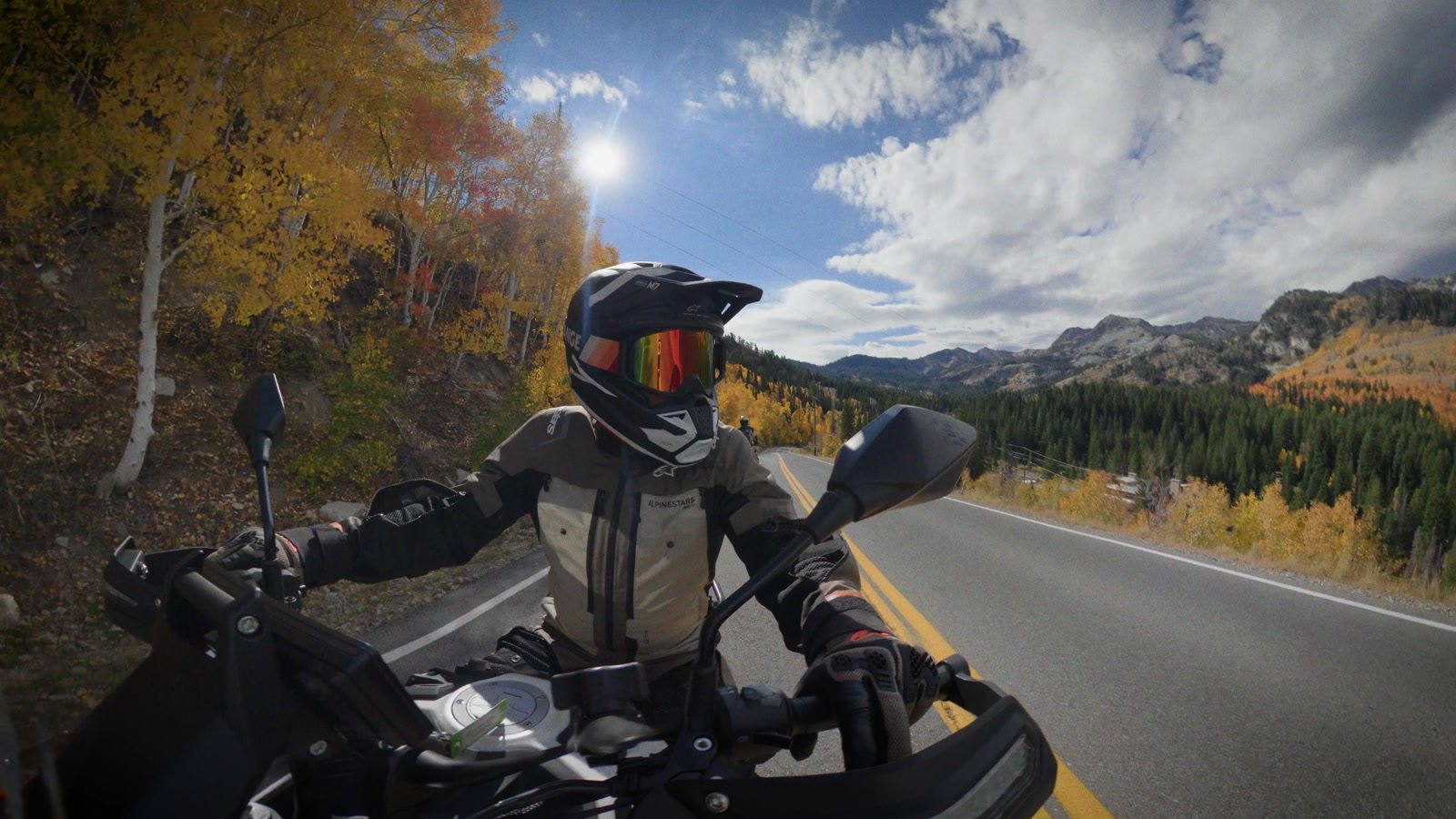 Riding the Moto Morini Vettore 450 on a canyon road lined with fall aspens
