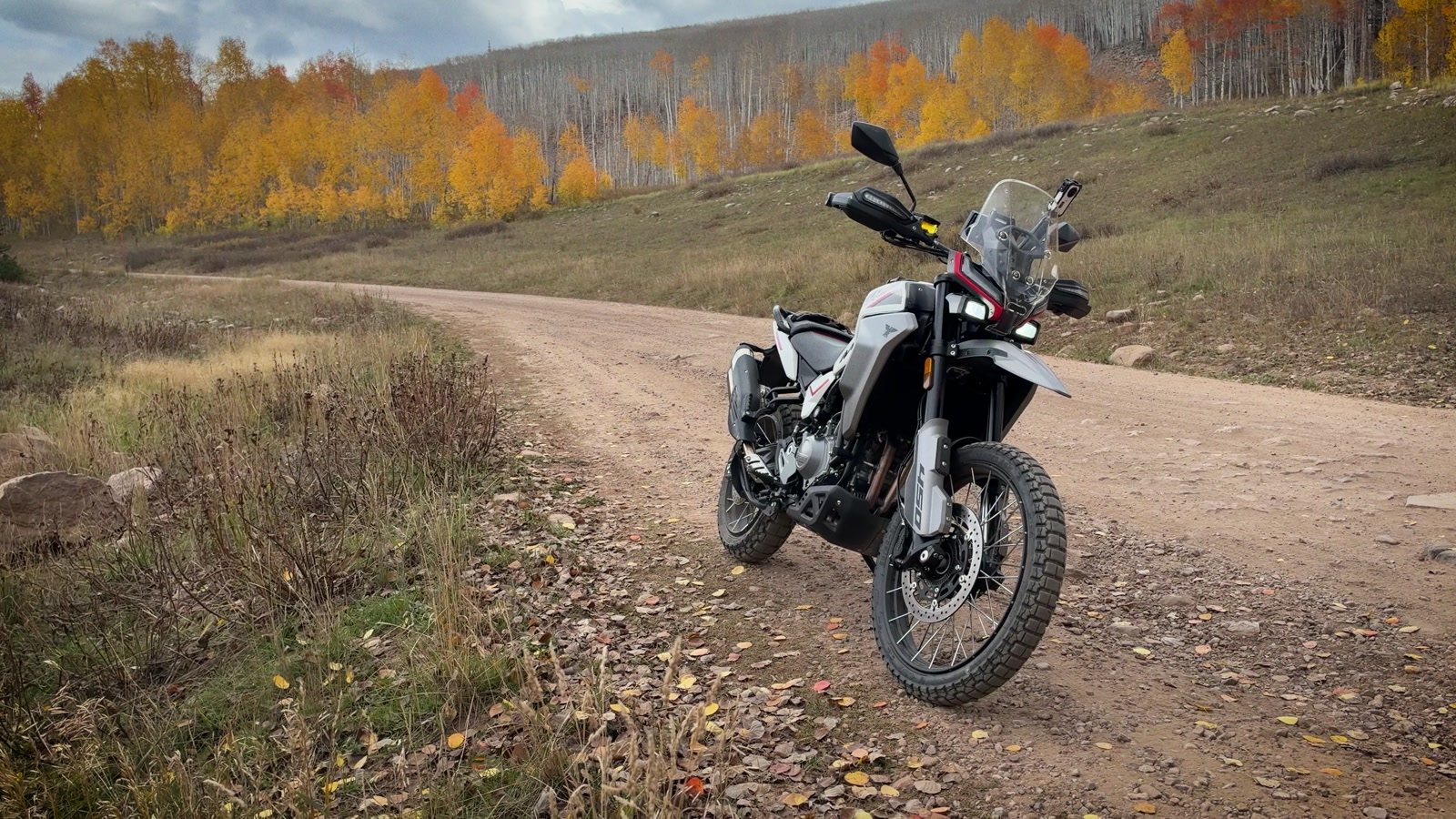 Moto Morini Vettore 450 parked on a dirt road with fall aspens behind it