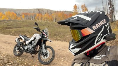 Moto Morini Vettore 450 parked on a Utah dirt road in fall aspens beside a rider in an Alpinestars helmet