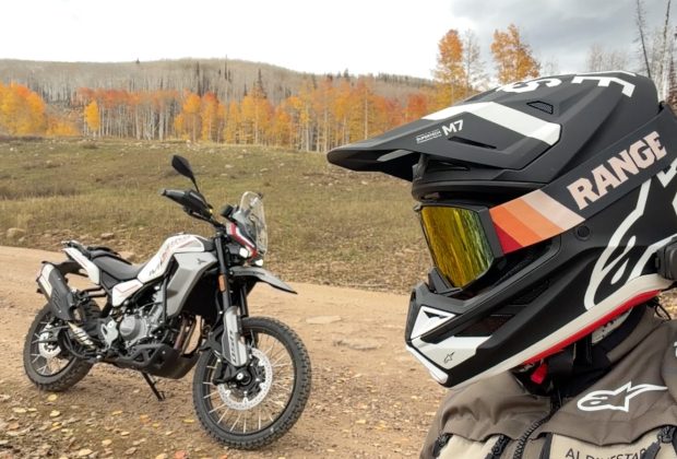 Moto Morini Vettore 450 parked on a Utah dirt road in fall aspens beside a rider in an Alpinestars helmet