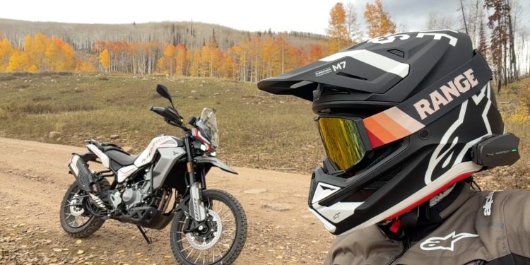 Moto Morini Vettore 450 parked on a Utah dirt road in fall aspens beside a rider in an Alpinestars helmet