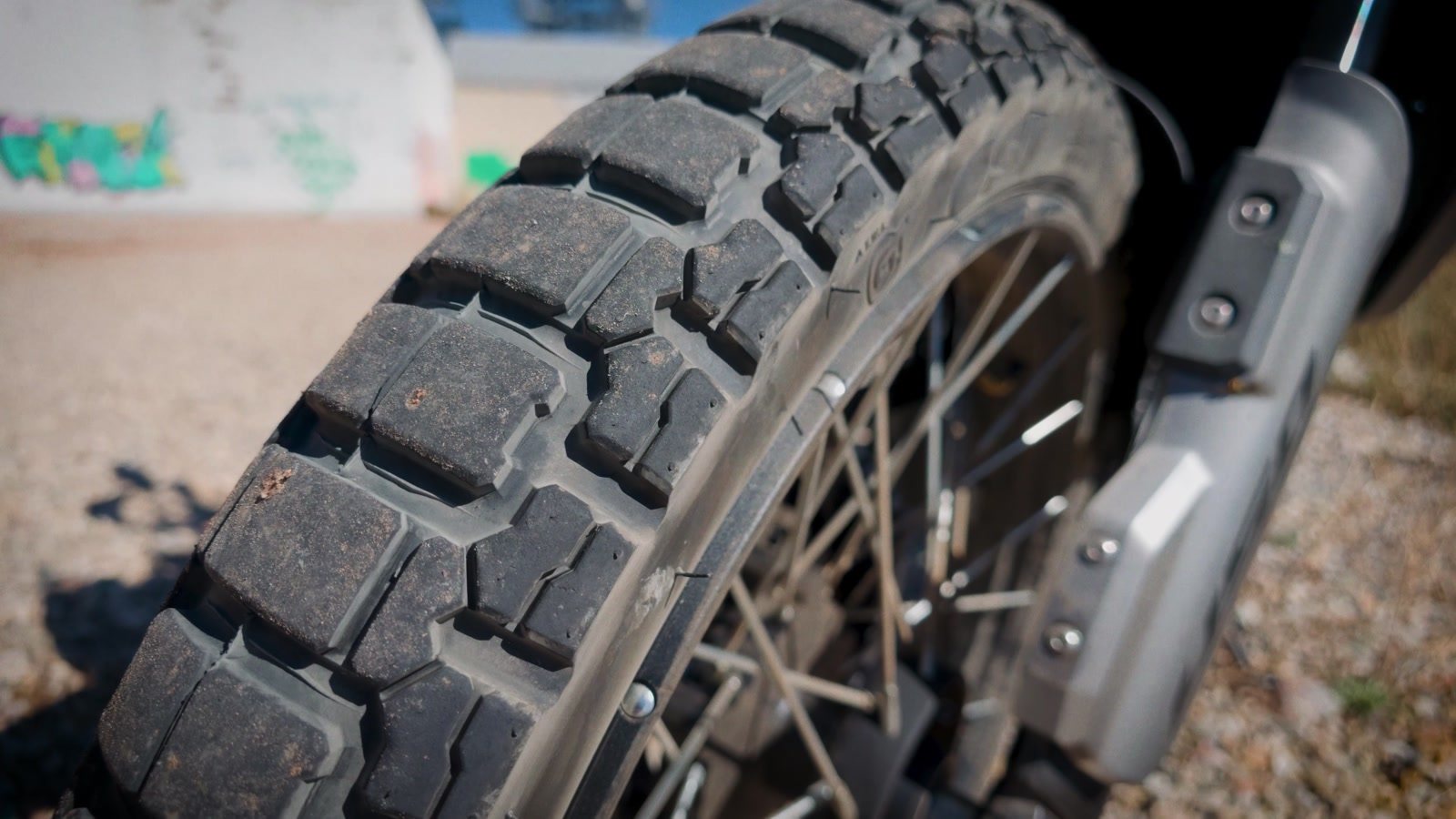 Close-up of the CST Ambro A4 front tire on the Moto Morini Vettore 450 spoked wheel